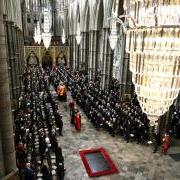 Members of the British royal family follow behind the coffin of Queen Elizabeth II as it is carried out of Westminster Abbey